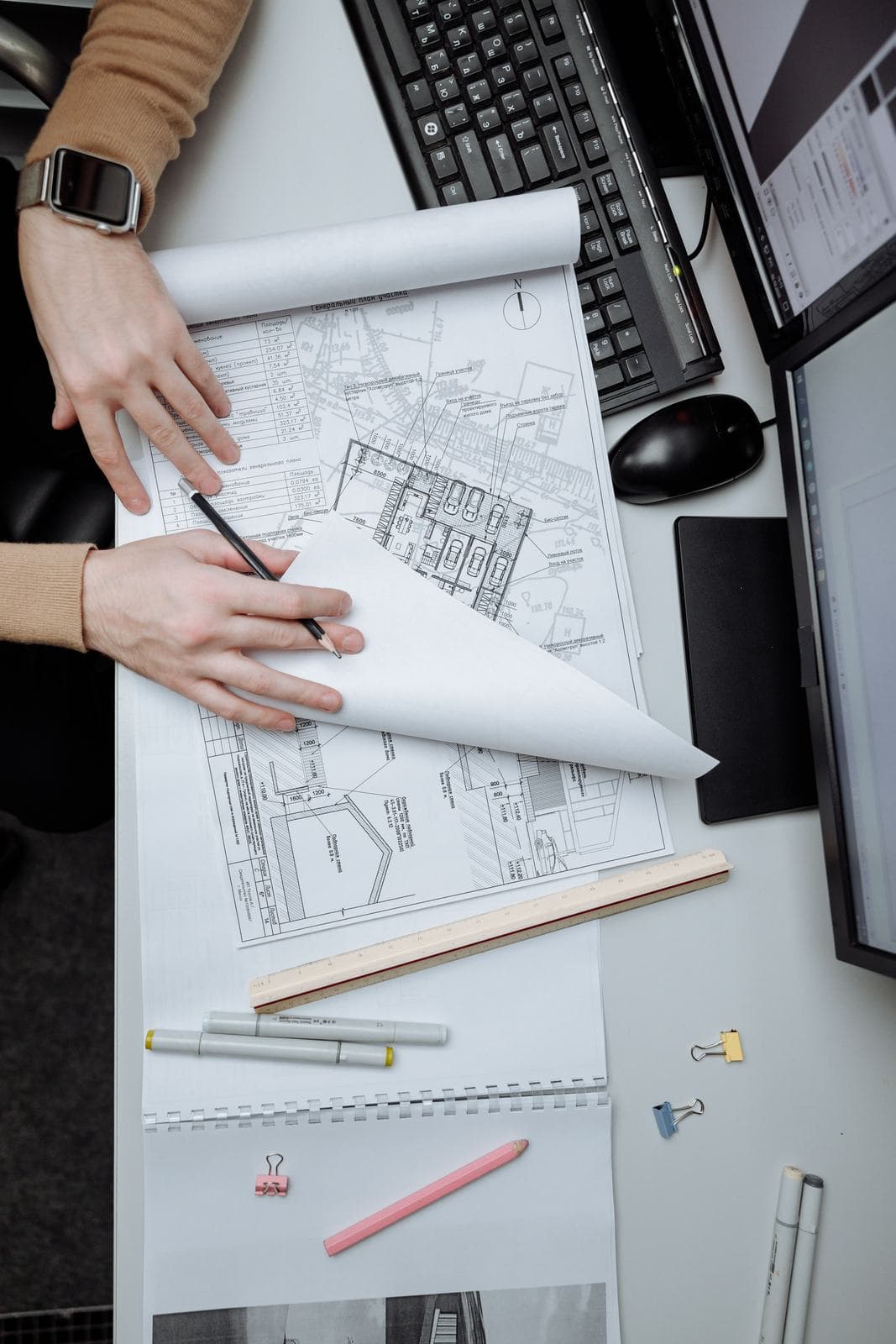 Distribution drawings reviewed at a drafting desk.