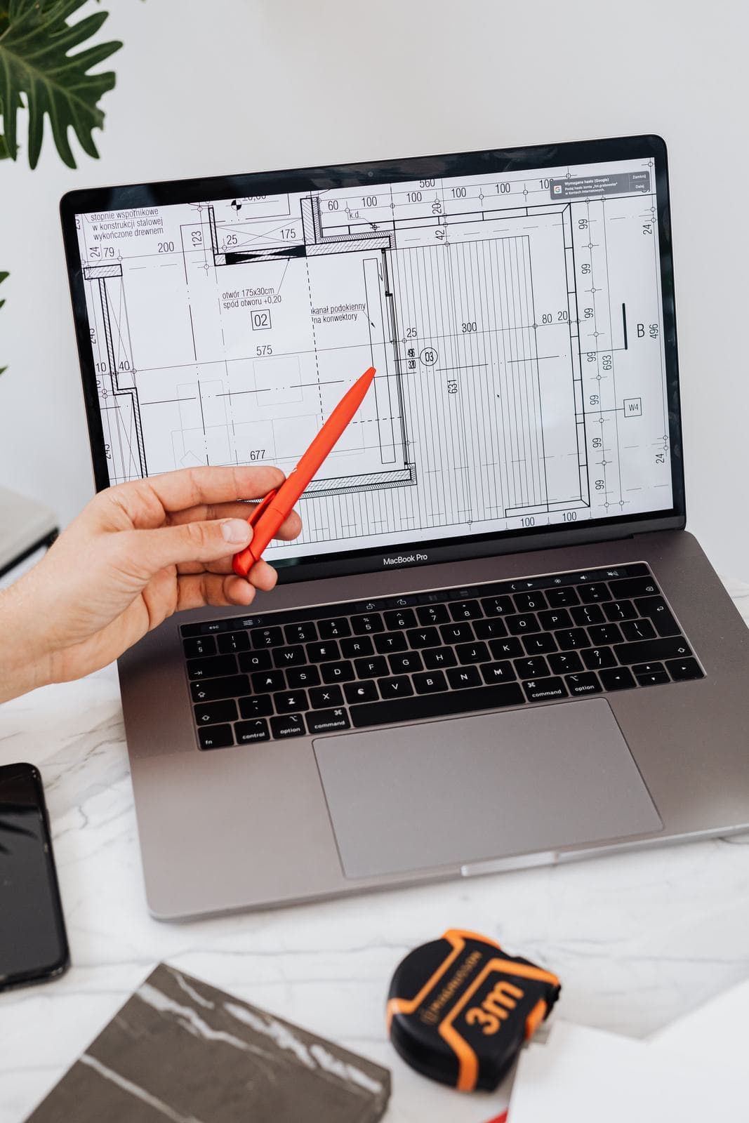 A distribution construction drawing open on a large CAD monitor.